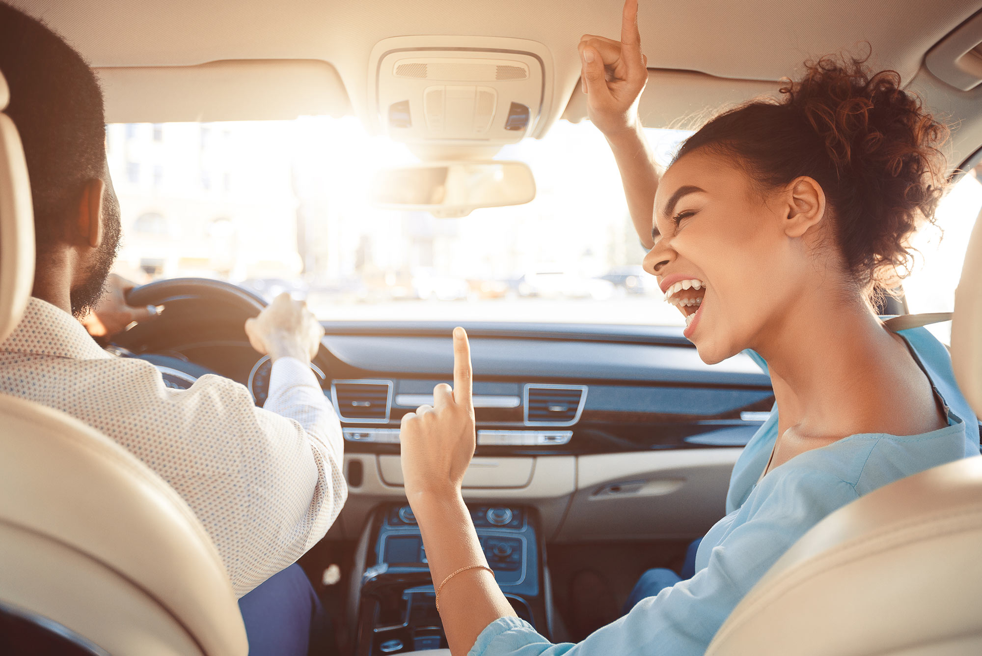 Photo of vehicle windshield with couple sitting in front seat