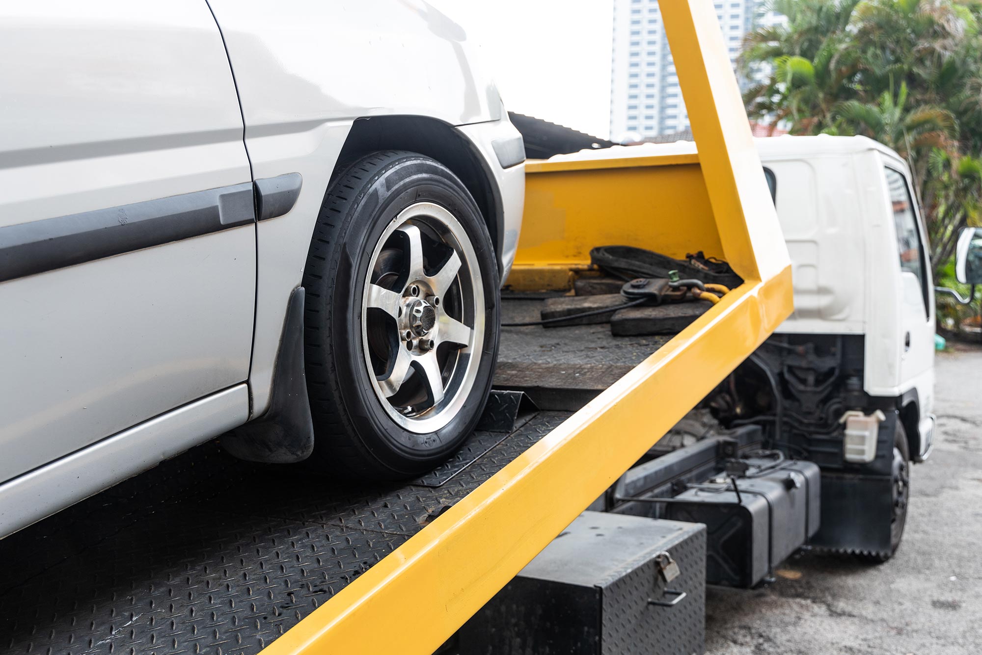 Photo of car on the bed of a tow truck